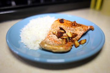 Plate of sockeye salmon with chopped garlic and basmati rice.
