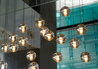 Small round designer glass lamps hanging in a spacious lobby