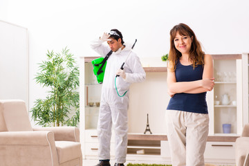 Young professional contractor doing pest control at flat 