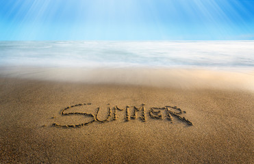The word summer carved on the sand is a good omen for the hot season that is about to arrive