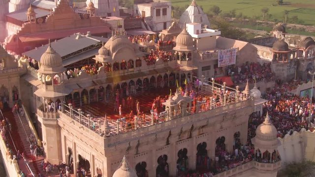 Color battle at the holi festival in India, 4k aerial shot 