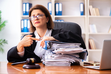 Middle-aged female doctor working in courthouse 