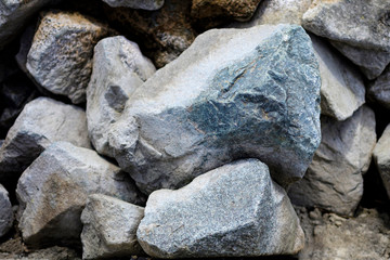 Stones of different sizes lie on the shore.