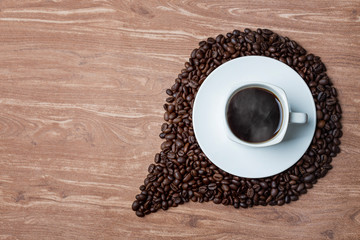 cup of coffee and beans on wooden table