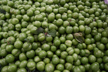 Green cherry plum fruit food background, top view.
