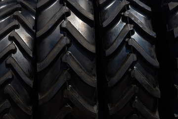 Stack of brand new tractor tires background, close-up