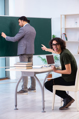 Young teacher and student in the classroom 