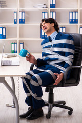 Young tied male employee in the office 
