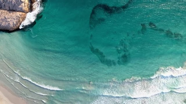 Aerial Descend: Vibrant Blue Ocean Waves Coming Onto Shore In Daylight - Esperance, Australia