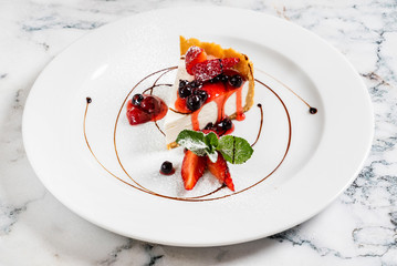 cheesecake with fresh strawberries and mint