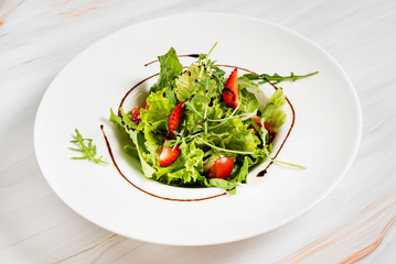 healthy salad with strawberriesa and arugula