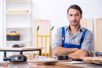 Obraz na płótnie Canvas Young male carpenter working indoors 
