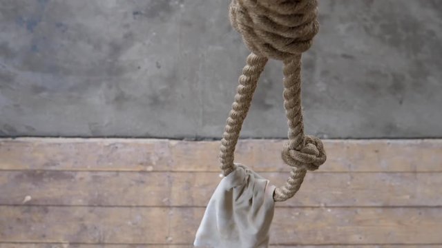 Noose with a hood on it to cover prisoner's face hanging in the prison execution room