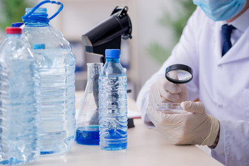 Young male chemist experimenting in lab