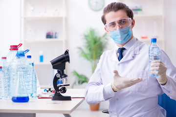 Young male chemist experimenting in lab