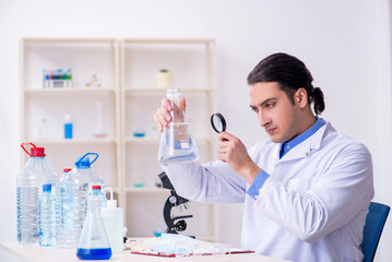 Young male chemist experimenting in lab