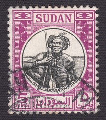 Obraz premium Warrior of the indigenous people of Shilluk, stamp Sudan 1951