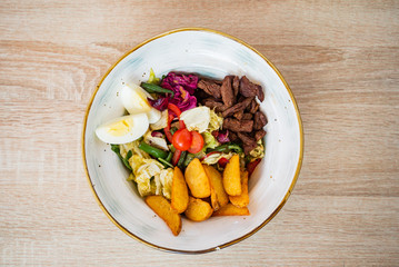 salad with baked potatoes and beef