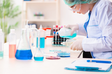Fototapeta premium Young female chemist working in the lab 