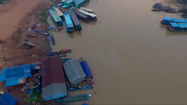Tilt over view of small sheds built by fishermen and bridge creating a passage for crossing the river.