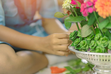 Students help each other to create a flowers tray with pedestal  for The Teachers’ Day