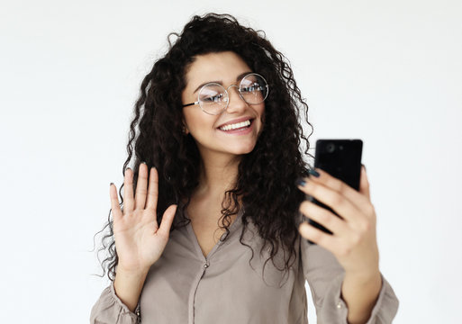 lifestyle, technology and people concept - young african woman taking selfie with smartphone