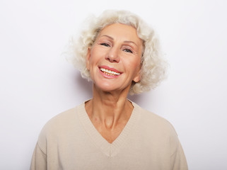 Fototapeta na wymiar lifestyle, emotion and people concept: Close up portrait of happy senior woman smiling