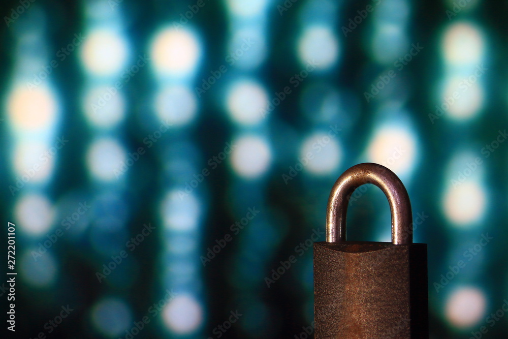 Poster padlock closed. padlock placed in front of circular defocus bokeh light. digital computer and intern