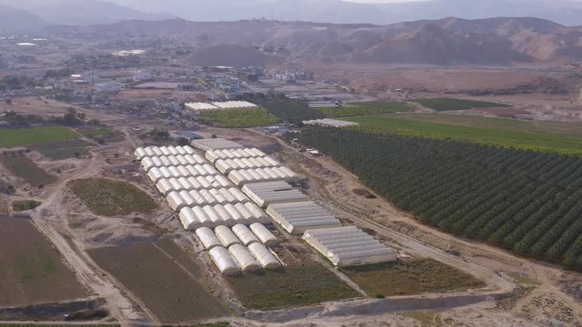 Flying above farming agricultural tents in south Israel kibbutz 4k aerial