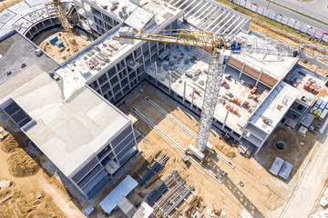 industrial tower crane standing high at construction site. public building under construction, top...
