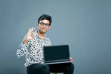 Young indian employee with laptop