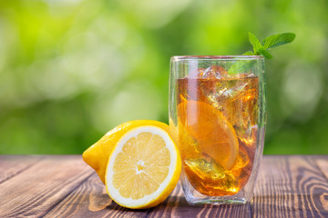 glass of ice tea on wooden table