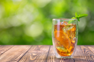 glass of ice tea on wooden table