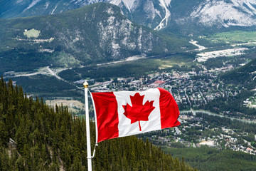 Canadian Maple Leafe Flag flying over mountains