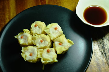 steamed Chinese dumpling filling minced pork or dim sum dipping soy sauce on plate