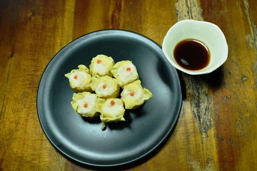 steamed Chinese dumpling filling minced pork or dim sum dipping soy sauce on plate