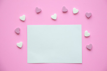 Blank paper card with heart on pink background.