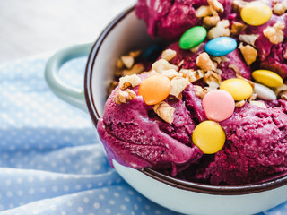 Bright, fruit ice cream on a vintage plate. White, isolated background. Close-up, top view. Concept of tasty and healthy food