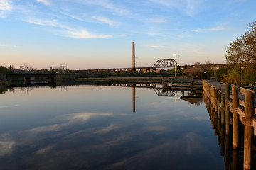 calm lake with steel bridge and boardwalk