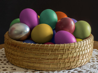 multi colored eggs in a wicker basket