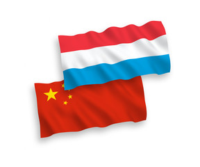 National vector fabric wave flags of Luxembourg and China isolated on white background 1 to 2 proportion.