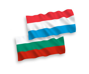 National vector fabric wave flags of Bulgaria and Luxembourg isolated on white background. 1 to 2 proportion.
