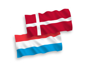 National vector fabric wave flags of Denmark and Luxembourg isolated on white background. 1 to 2 proportion.