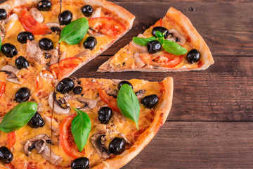 Tasty fresh hot pizza against a dark background. Pizza, food, vegetable, mushrooms.  It can be used as a background