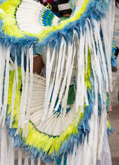 Close Up of a White, Blue and Yellow Headdress and Bustle at a Pow Wow
