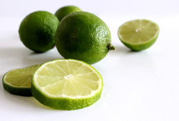 Lime. Fresh fruit isolated on white background. Slice, piece, half, quarter. Rich of nutrients, fiber, and vitamins. Picture design for foods background.