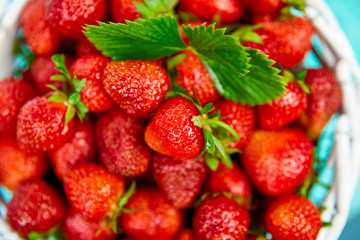 Ripe red strawberries on blue table, Strawberries in white basket. Fresh strawberries. Beautiful strawberries. Diet food. Healthy, vegan. Top view. Flat lay.