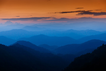 Majestic sunset sky over blue mountains layers landscape