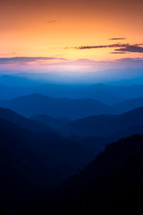 Majestic sunset sky over blue mountains layers landscape