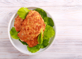 Chicken schnitzel over lettuce